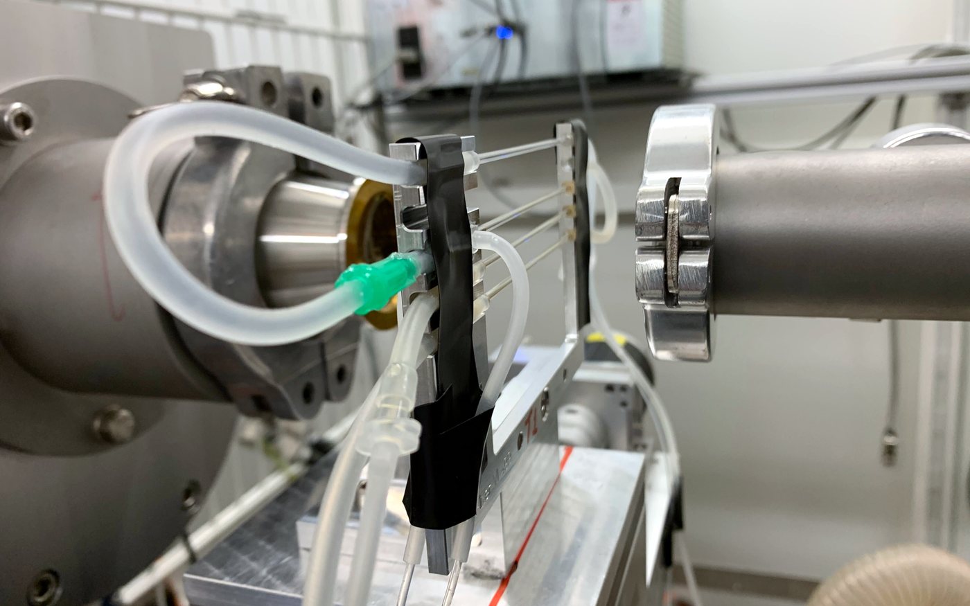 Microfluidic flow cell mounted in the beam at DESY beamline P12, with reagent reservoirs and tubing